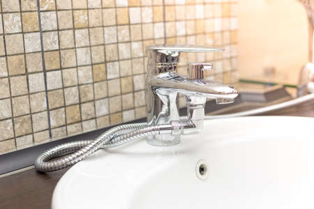 wooden countertop in a modern bathroom white porcelain sink with shower