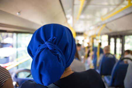 Young woman sitting on a bus. Photo taken from behind.の写真素材