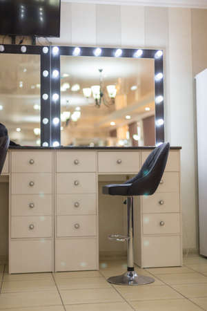 Decorative cosmetics and dressing table near the mirror in the dressing roomの写真素材