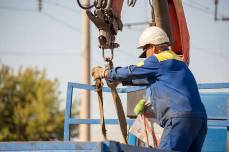 workers replace old reinforced concrete sleepers with new ones on the railway using machineryの写真素材