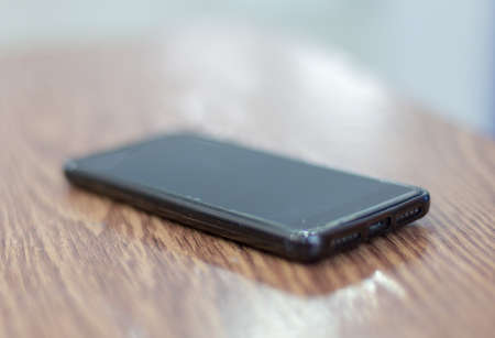 black smartphone on the tableの写真素材