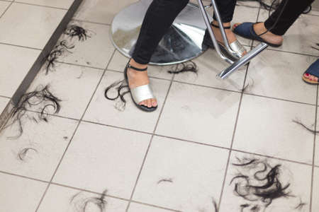 Hair on the floor in the hairdresser. Legsの写真素材