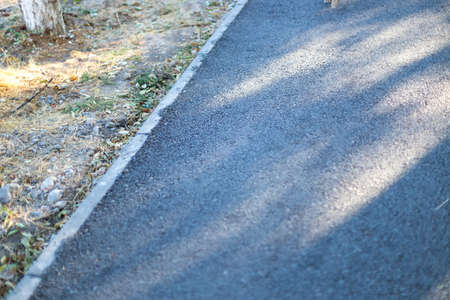 sidewalk, asphalt pavement along the road