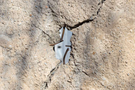 cracked concrete cement wall in industrial building, great for your design and texture backgroundの写真素材