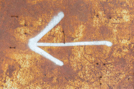 Rusty metal background with arrow and scratches.