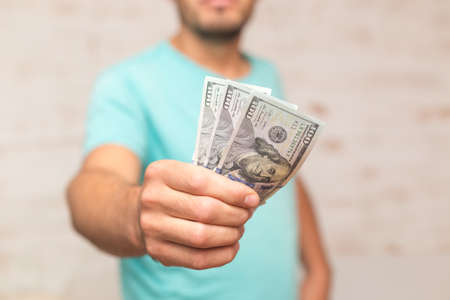 Man's hands holding hundred dollar bills. Business conceptの写真素材