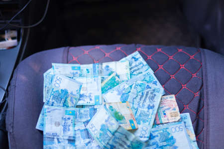 Kazakh money in a car seatの写真素材