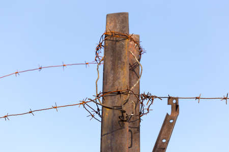 Barbed wire fence. Let. Prison. Spikes. Block. Prisoner.の写真素材