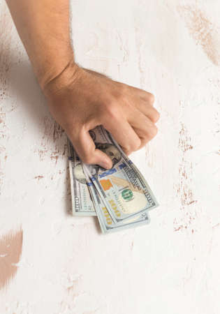 Man's hands holding hundred dollar bills. Business concept