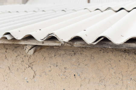 Old wavy roofs cover the barnの写真素材