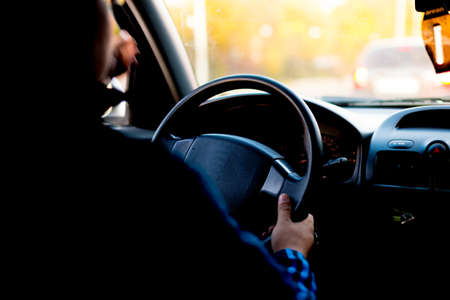 Close Up Man Hands Holding Steering Wheel While Driving A Car.の写真素材