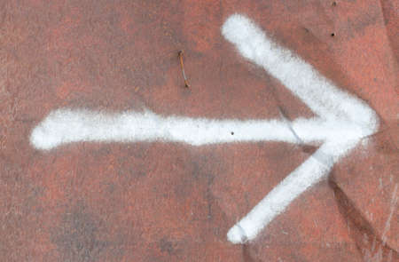 Rusty metal background with arrow and scratches.の写真素材