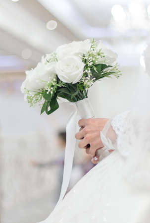 closeup of bride hands holding beautiful wedding bouquetの写真素材