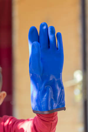 warm, blue rubber glove for construction work in the coldの写真素材