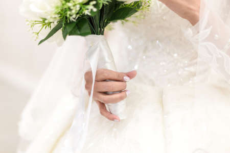 closeup of bride hands holding beautiful wedding bouquetの写真素材