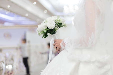 closeup of bride hands holding beautiful wedding bouquetの写真素材
