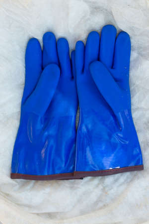 warm, blue rubber glove for construction work in the coldの写真素材