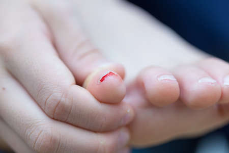 mom cuts baby's nails with protective scissorsの写真素材