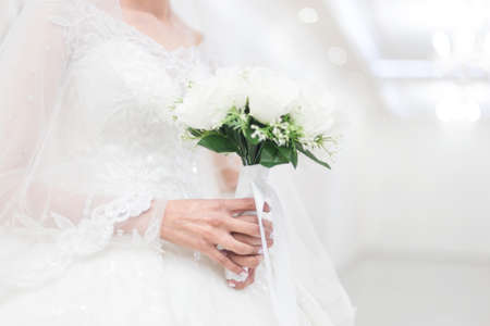 closeup of bride hands holding beautiful wedding bouquetの写真素材