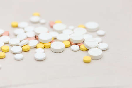 Colorful medical pills on the table, for your textの写真素材