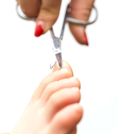 mom cuts baby's nails with protective scissorsの写真素材