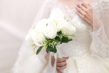 closeup of bride hands holding beautiful wedding bouquetの写真素材