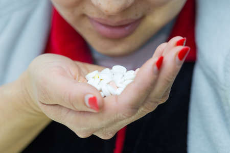 girl wants to drink a lot of pills on a white background