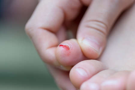 mom cuts baby's nails with protective scissorsの写真素材