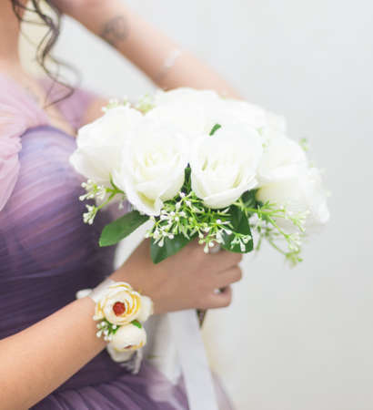 closeup of bride hands holding beautiful wedding bouquetの写真素材