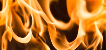 Fire flame burning glowing on black dark background, hot heat energy fuel fire motion pattern abstract texture.の写真素材