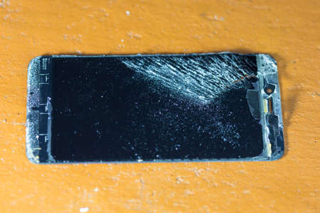 Dismantling a smartphone on a yellow tableの写真素材