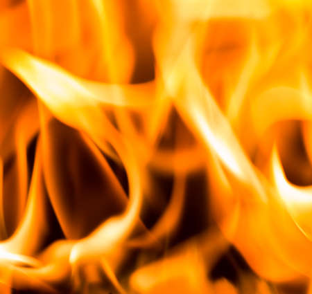 Fire flame burning glowing on black dark background, hot heat energy fuel fire motion pattern abstract texture.の写真素材