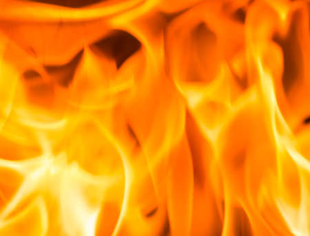 Fire flame burning glowing on black dark background, hot heat energy fuel fire motion pattern abstract texture.の写真素材