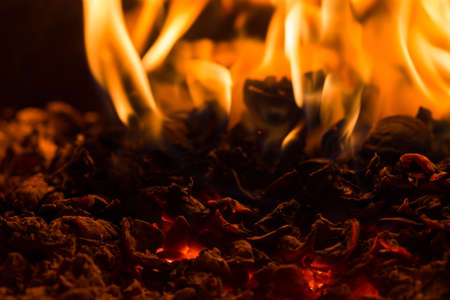 Fire flame burning glowing on black dark background, hot heat energy fuel fire motion pattern abstract texture.の写真素材
