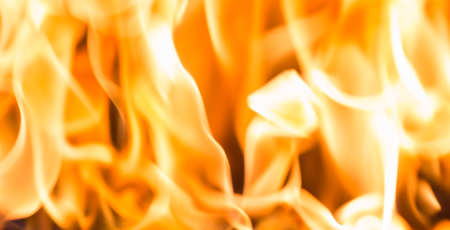 Fire flame burning glowing on black dark background, hot heat energy fuel fire motion pattern abstract texture.の写真素材