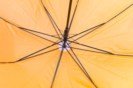 Interior view of a yellow umbrella: ribs and tentの写真素材