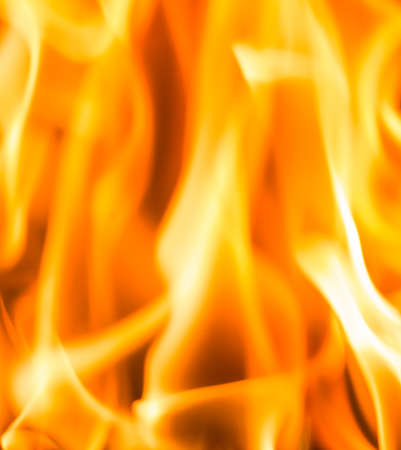 Fire flame burning glowing on black dark background, hot heat energy fuel fire motion pattern abstract texture.の写真素材