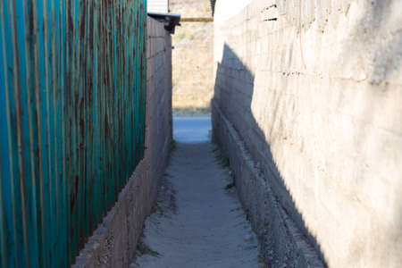 Narrow alley between two fencesの写真素材