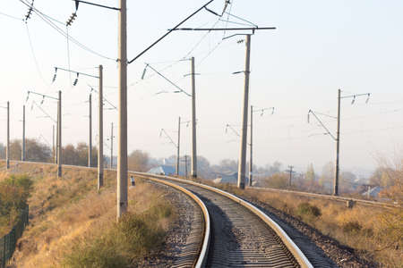 railway rails pillars wire horizonの写真素材
