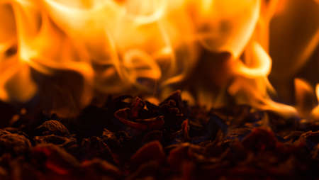 Fire flame burning glowing on black dark background, hot heat energy fuel fire motion pattern abstract texture.の写真素材