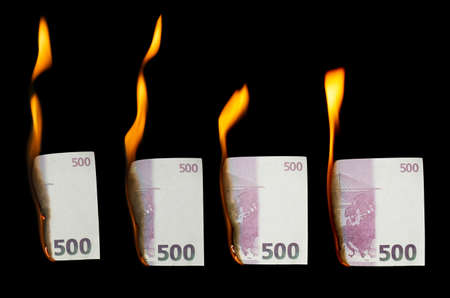 collage of 500 euros burns on a black backgroundの写真素材