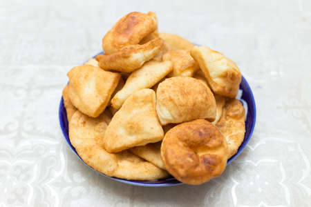 Baursak traditional Mongolian food in a plate on the tableの写真素材