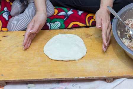 woman prepares soft, juicy korean mantiの写真素材