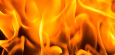 Fire flame burning glowing on black dark background, hot heat energy fuel fire motion pattern abstract texture.の写真素材