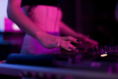 DJ mixing in a karaoke bar. Soft focus on hand - a concept of entertainment, youth, entertainment and relaxationの写真素材