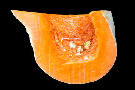 Sliced orange pumpkin, pulp close-up. Isolated on a black background.の写真素材