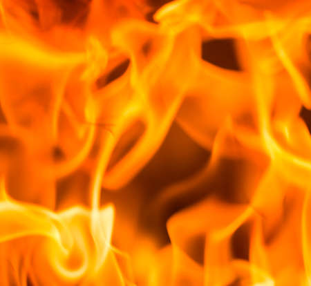 Fire flame burning glowing on black dark background, hot heat energy fuel fire motion pattern abstract texture.の写真素材