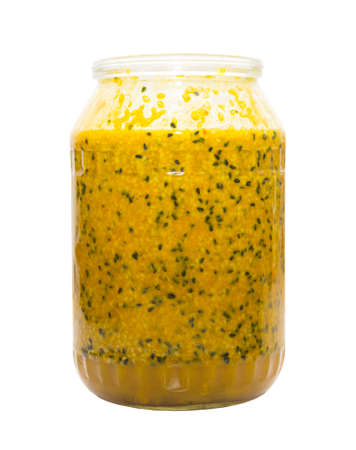 Therapeutic mixture with honey from sesame, turmeric, caraway and ginger on a glass jar on a white backgroundの写真素材