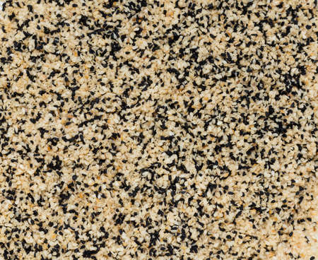 abstract background of fried sesame seeds and caraway seedsの写真素材