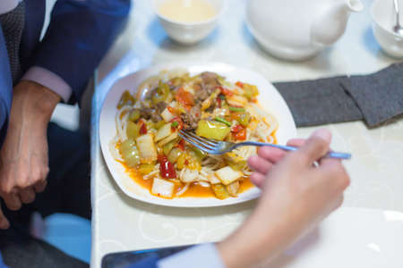 Man eating noodles in a cafe during lunch